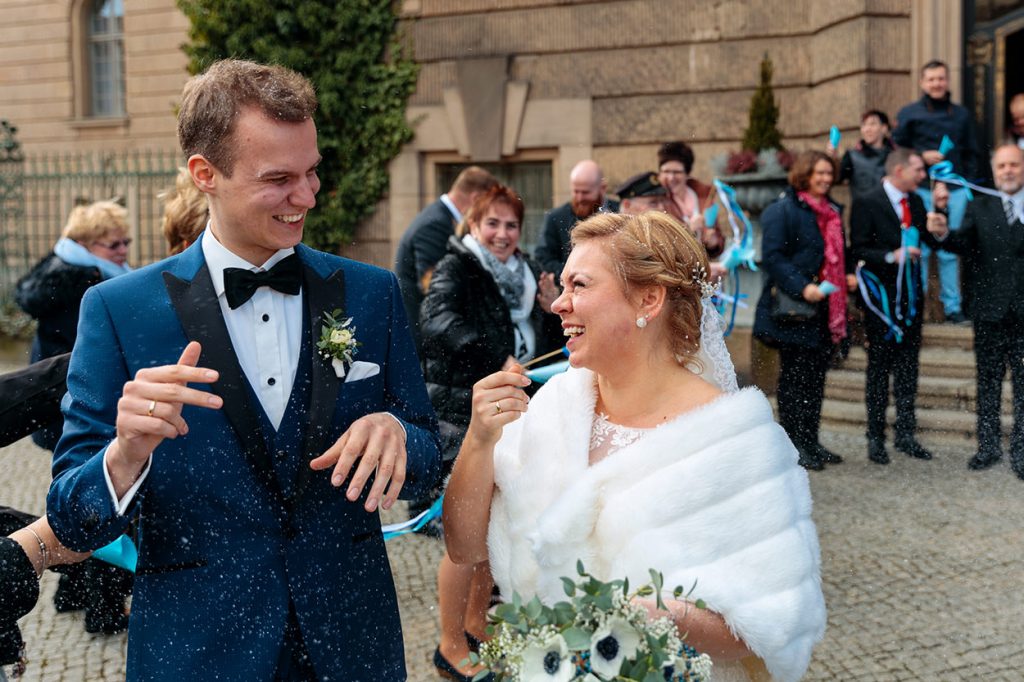 Braut und Bräutigam freuen sich nach Reiswurf vor dem Standesamt in Potsdam Verheiratet! So schnell kann es gehen
