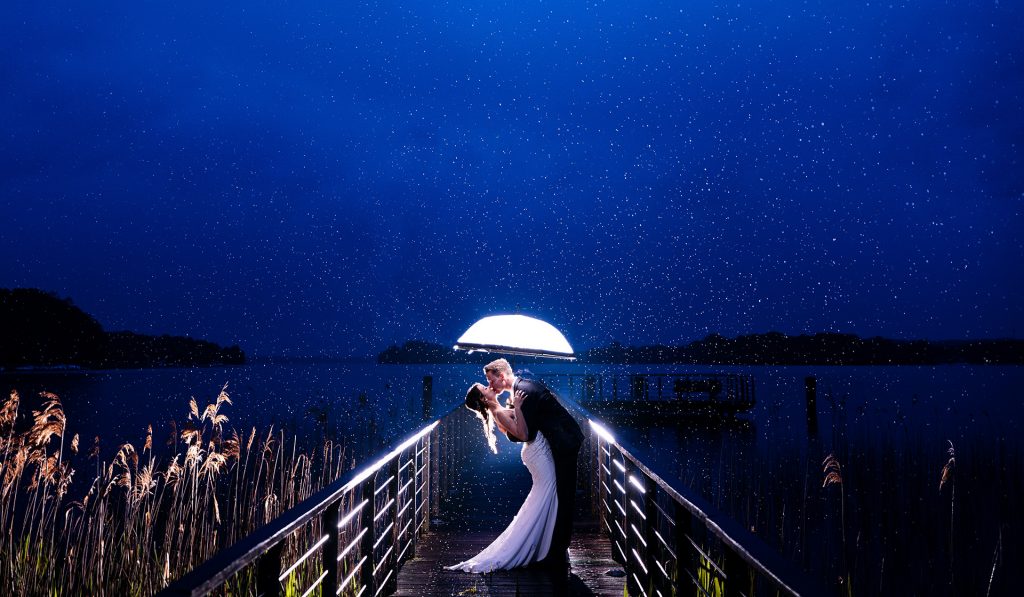 Hochzeitsfoto mit Brautpaar im Regen auf einem Steg in Brandenburg Bad Saarow
