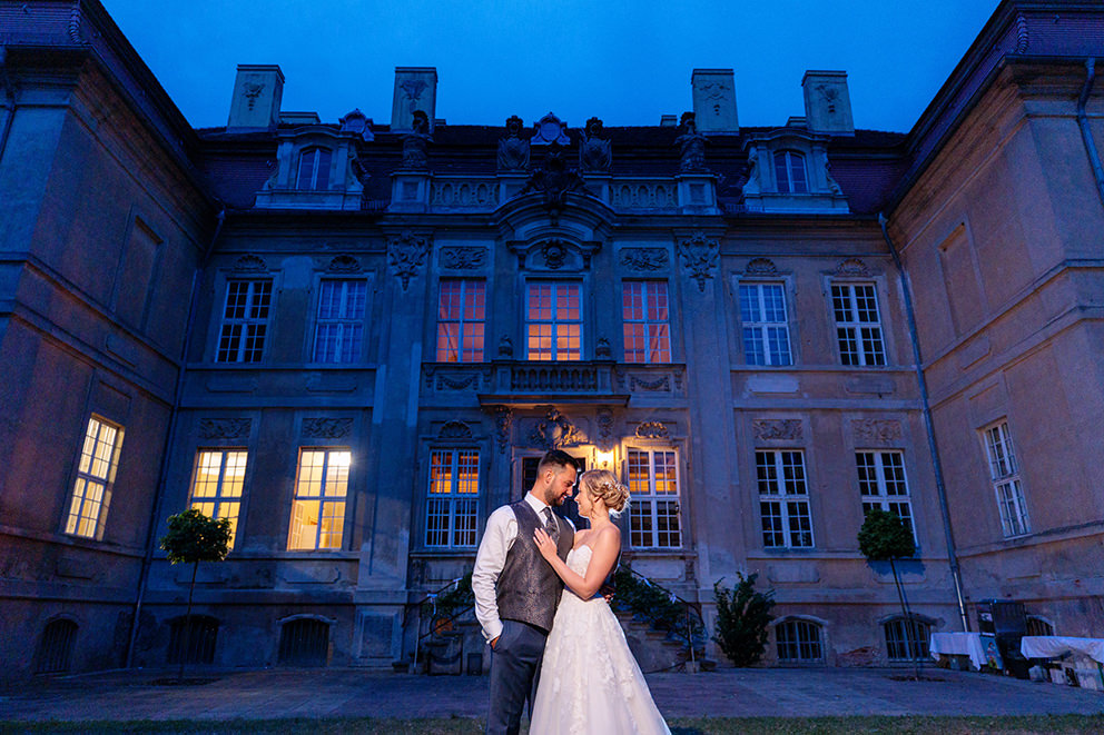 Hochzeitsfotos mit Brautpaar zum Abend vor einem alten Schloss