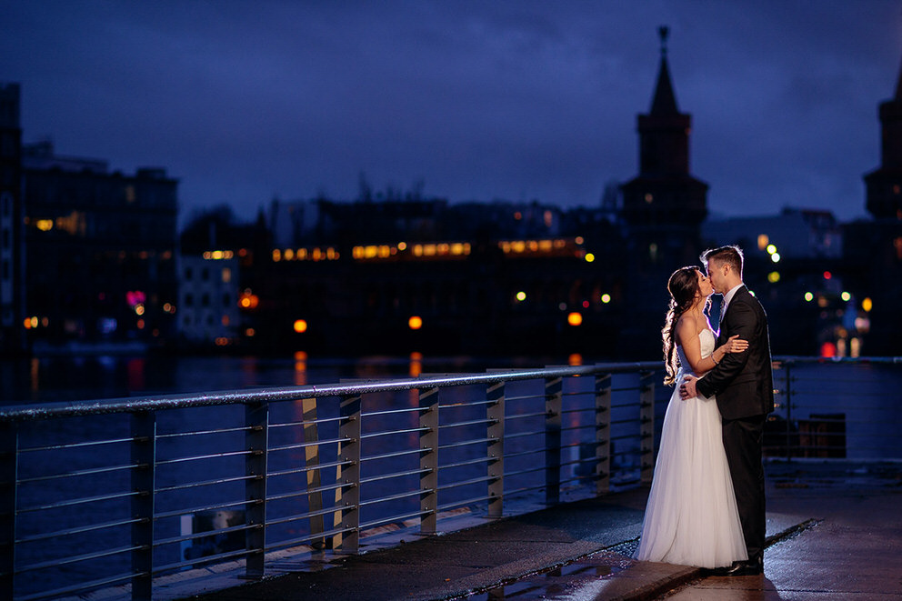 Küssendes Brautpaar vor der Oberbaumbrücke zur blauen Stunde bei Winterhochzeit in Berlin Küssendes Brautpaar vor der Oberbaumbrücke zur blauen Stunde bei Winterhochzeit in Berlin