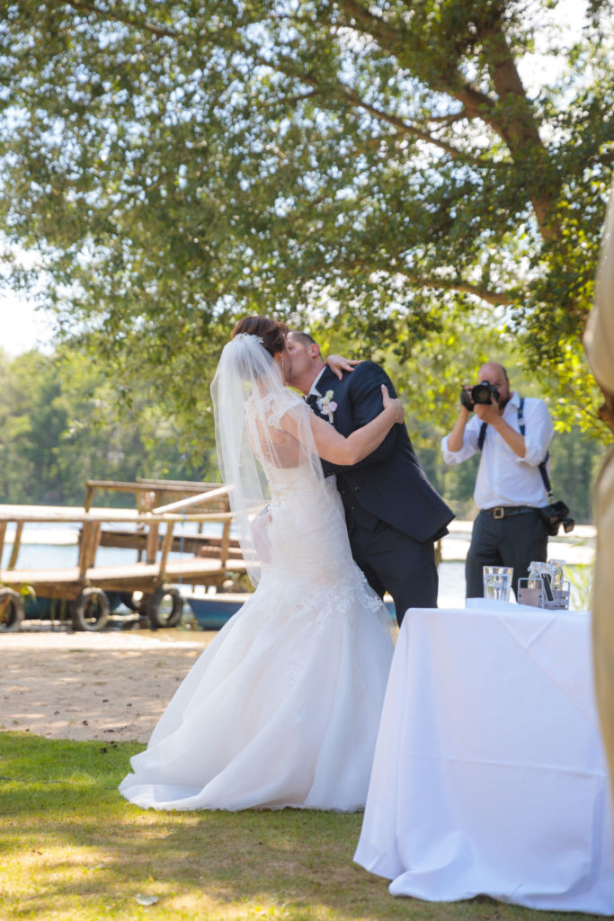 a freshly married wedding couple kisses right after the ceremony in Brandenburg
