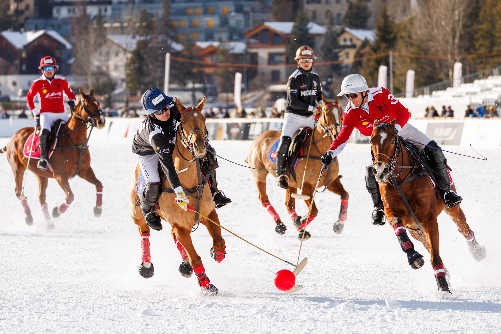 A photograph at a polo game on the frozen lake of St Moritz in january 2026 showing players of Team Mackage and Team City of St. Moritz fighting for the polo ball on snow